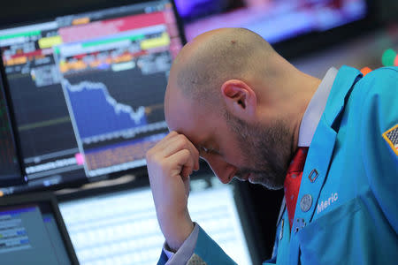 FILE PHOTO: A trader works on the floor at the New York Stock Exchange (NYSE) in New York City, New York, U.S., December 4, 2018. REUTERS/Brendan McDermid/File Photo