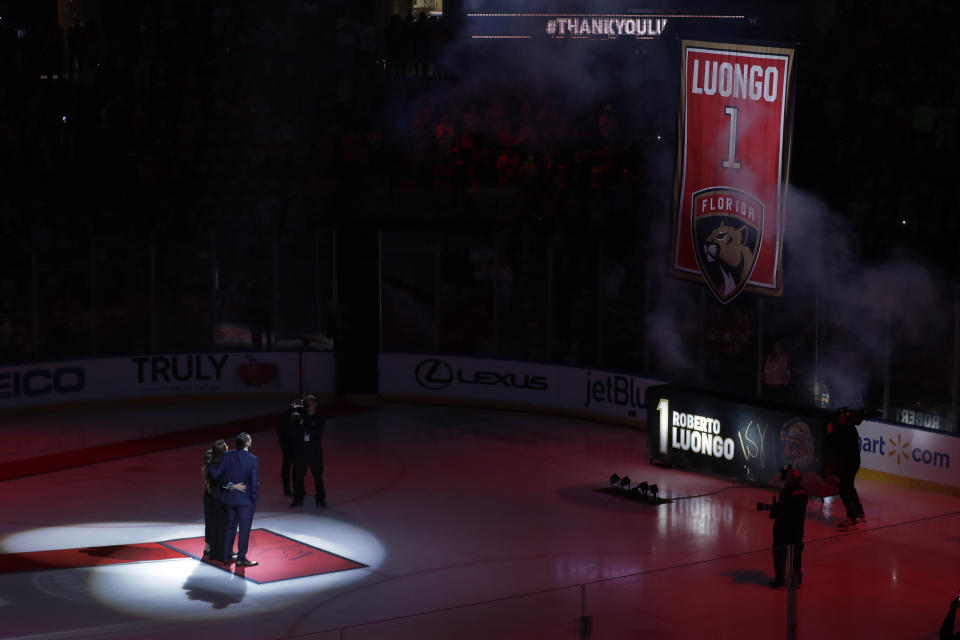 Former Florida Panthers goalie Roberto Luongo, left, and his family watch as his jersey is hoisted to the rafters during a ceremony before an NHL hockey game against the Montreal Canadiens, Saturday, March 7, 2020, in Sunrise, Fla. (AP Photo/Wilfredo Lee)