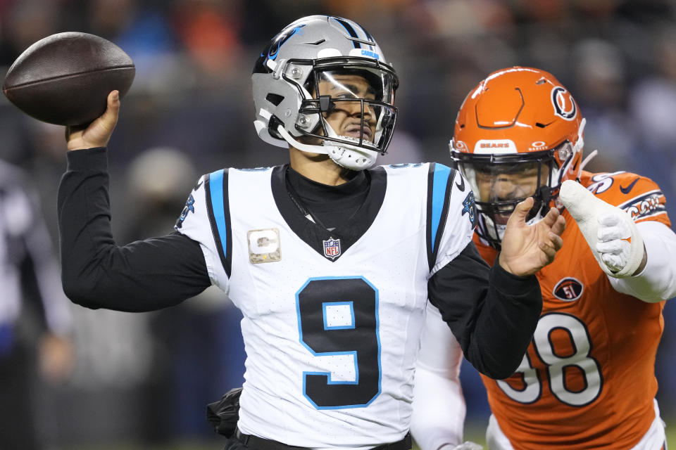 Carolina Panthers quarterback Bryce Young (9) throws under pressure from Chicago Bears defensive end Montez Sweat (98) during the first half of an NFL football game Thursday, Nov. 9, 2023, in Chicago. (AP Photo/Charles Rex Arbogast)
