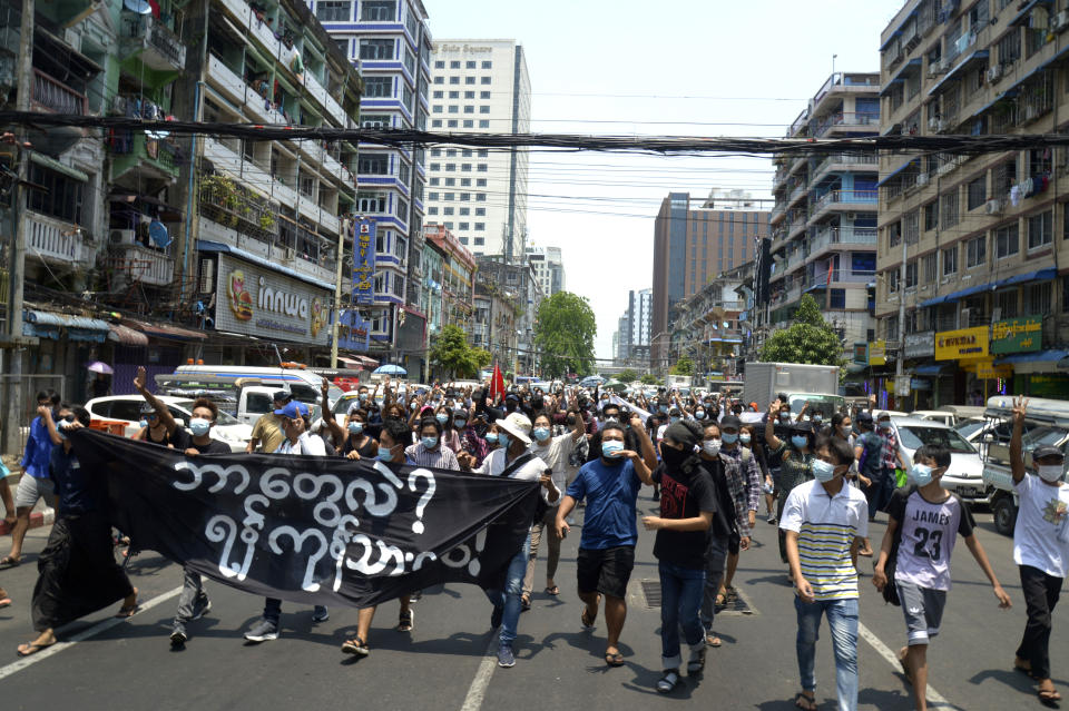 Anti-coup protesters march on a street with banner read " What we are? We are Yangon! People!", during a demonstration in Yangon, Myanmar, Friday, April 23, 2021. Leaders of the 10-member Association of Southeast Asian Nations meet Saturday, April 24, in Jakarta to consider plans to promote a peaceful resolution of the conflict that has wracked Myanmar since its military launched a deadly crackdown on opponents to its seizure of power in February. (AP Photo)