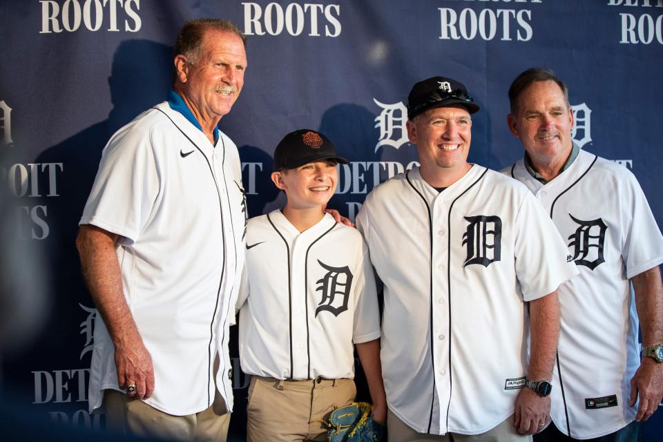 Mike Gehringer and his Alex, 13, both of Saline take a photo with Tigers 1984 World Series team members Dan Petry, left, and Howard Johnson during the Summer Baseball Bash at Comerica Park in Detroit, Saturday, July 17, 2021.