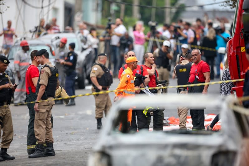 A wrecked car is seen at the site where a small plane crashed on a residential street in Belo Horizonte