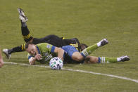Seattle Sounders' Brad Smith, front, and Columbus Crew's Luis Diaz fall to the ground after a collision during the second half of the MLS Cup championship game Saturday, Dec. 12, 2020, in Columbus, Ohio. The Crew won 3-0. (AP Photo/Jay LaPrete)