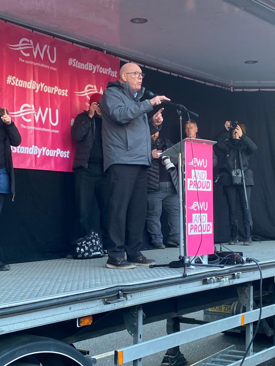 General Secretary of the Communication Workers Union Dave Ward addresses striking workers on stage at Parliament Square rally on 9 December. (Mustafa Qadri/The Independent)