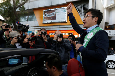 Pro-democracy candidate Au Nok-hin campaigns in a car during a Legislative Council by-election in Hong Kong, China March 11, 2018. REUTERS/Bobby Yip