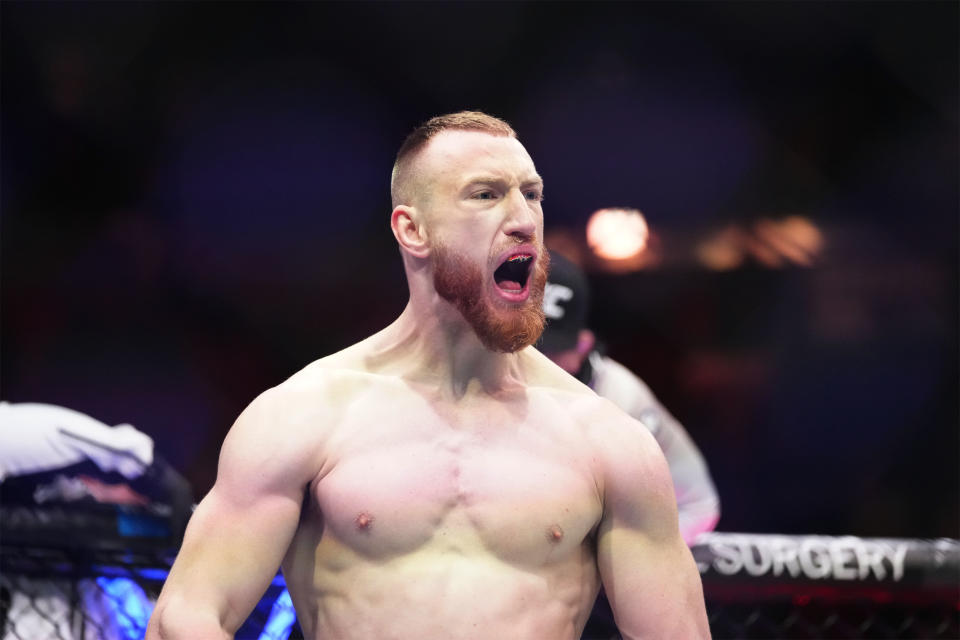 Apr 8, 2023; Miami, Florida, USA; Joe Pyfer (blue gloves) celebrates defeating Gerald Meerschaert (red gloves) during UFC 287 at Miami-Dade Arena. Mandatory Credit: Rich Storry-USA TODAY Sports