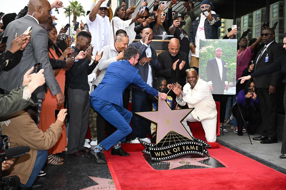 Sekyiwa Shakur, sister of US rapper Tupac Shakur, and Mopreme Shakur, step brother of US rapper Tupac Shakur, unveil Tupac's star during his Hollywood Walk of Fame star ceremony in Hollywood, California, on June 7, 2023. (AFP via Getty Images)