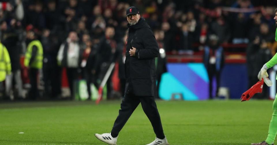 Liverpool boss Jurgen Klopp walks across the pitch Credit: Alamy