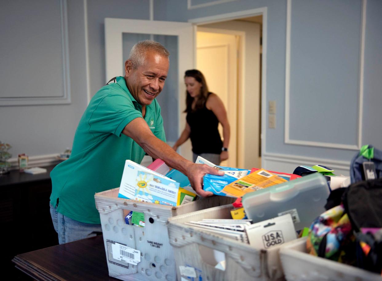 Hector Reyes of HomeSafe and Town of Palm Beach United Way director of marketing and communications Aleese Kopf pack up school supplies for children and families on Aug. 9, 2022. HomeSafe was one on the beneficiaries of last year's drive.