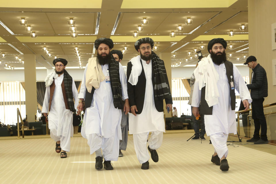 FILE- In this Feb. 29, 2020, file, photo, Afghanistan's Taliban delegation arrive for the agreement signing between Taliban and U.S. officials in Doha, Qatar. Taliban officials said Friday, July 17, 2020 that the son of the movement’s feared founder has been put in charge of its military wing and added powerful figures to its negotiating team ahead of expected talks aimed at ending Afghanistan’s decades of war, The moves mark one of the most significant shake-ups in years. (AP Photo/Hussein Sayed, File)