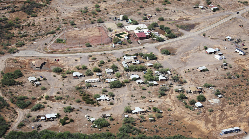 The earthen Menagers Dam that was in imminent danger of failing, potentially sending floodwaters rushing into this Tohono O'odham village of Ali Chuk, has held steady as the lake behind it receded Wednesday, Oct. 3, 2018, southwest of Sells, Ariz. Evacuations had begun Tuesday night after Hurricane Rosa's remnants drenched the western half of Arizona. (Mike Christy/Arizona Daily Star via AP)