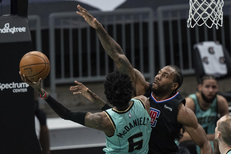 Charlotte Hornets forward Jalen McDaniels (6) drives to the basket while guarded by Los Angeles Clippers forward Kawhi Leonard during the first half of an NBA basketball game in Charlotte, N.C., Thursday, May 13, 2021. (AP Photo/Jacob Kupferman)