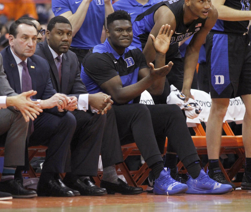 Duke's Zion Williamson, center, cheers after a basket from the bench during the second half of an NCAA college basketball game against Syracuse in Syracuse, N.Y., Saturday, Feb. 23, 2019. Duke won 75-65. (AP Photo/Nick Lisi)