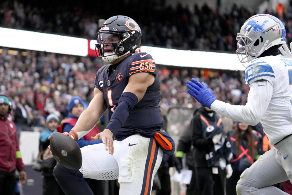 Chicago Bears quarterback Justin Fields scores a rushing touchdown past Detroit Lions safety Kerby Joseph during the second half of an NFL football game Sunday, Dec. 10, 2023, in Chicago. (AP Photo/Nam Y. Huh)