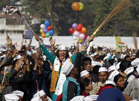 A supporter of Aam Aadmi (Common Man) Party (AAP) cheers after its leader Arvind Kejriwal took an oath as the new chief minister of Delhi during a swearing-in ceremony at Ramlila ground in New Delhi December 28, 2013. REUTERS/Anindito Mukherjee