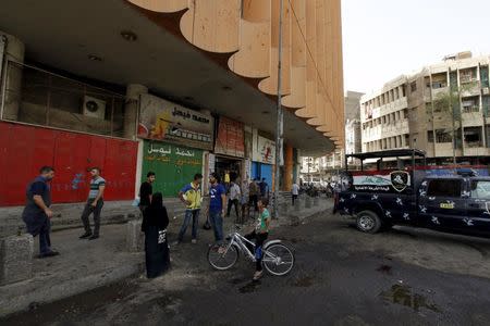 People gather at the site of a suicide bomb attack in Baghdad, Iraq, September 17, 2015. REUTERS/Ahmed Saad