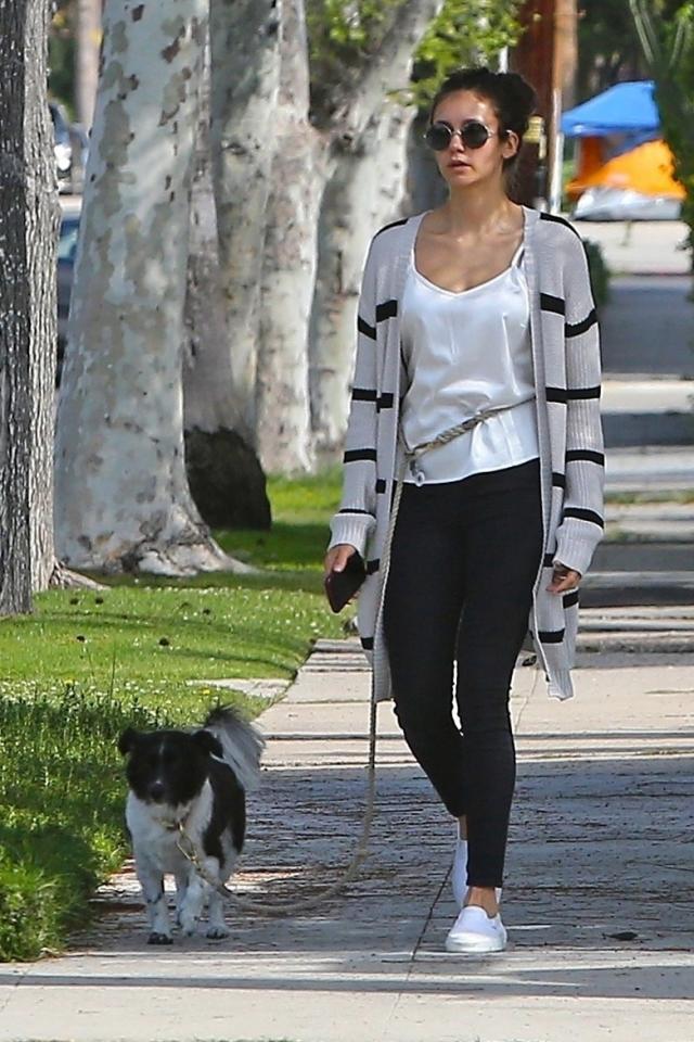 Abby Champion sports a white hoodie and black leggings during a power walk  in Brentwood, California