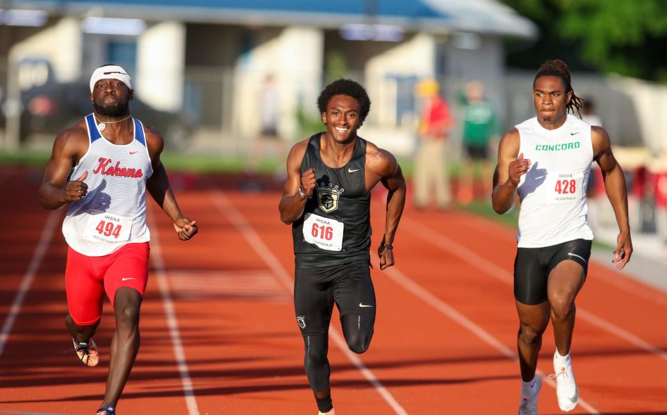 Plez Lawrence of Kokomo (494), Alec Hardrict of Penn (616), and Jaton Thomas of Concord (428) compete in the final of the 100 Meter Dash Thursday night during the Boys Track & Field Regional at Goshen High School.