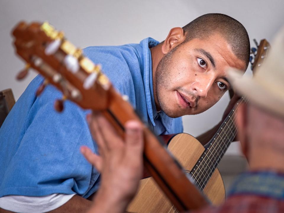 Peter Merts photos show California Prison Arts Programs A guitar student and his instructor at North Kern State Prison - 2018