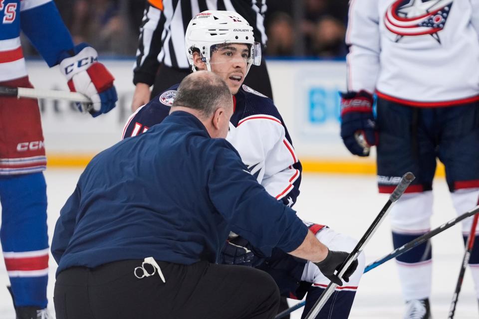 A trainer checks on Columbus Blue Jackets' Johnny Gaudreau during the second period of the team's NHL hockey game against the New York Rangers on Wednesday, Feb. 28, 2024, in New York. (AP Photo/Frank Franklin II)