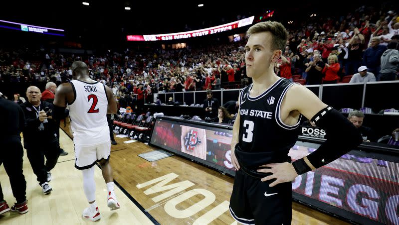 Utah State Aggies guard Steven Ashworth (3) watches as San Diego State celebrates after winning the Mountain West Conference Basketball Tournament Championship at UNLV’s Thomas and Mack Center in Las Vegas on Saturday, March 11, 2023. San Diego State won 62-57.