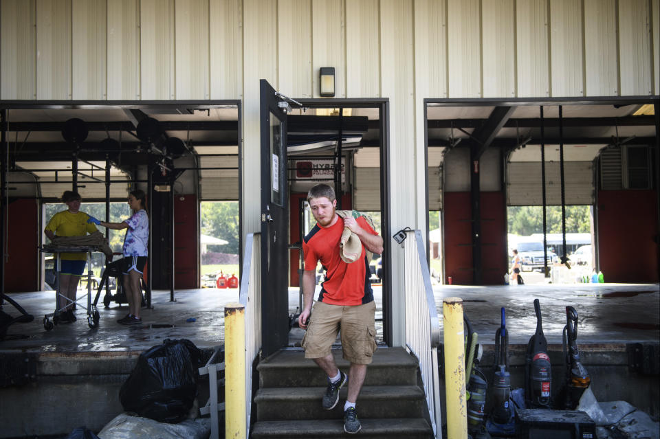 Jacob Hash helps clean out Evolution Athletics on Thursday, Sept. 20, 2018, on Bragg Boulevard in Spring Lake, N.C. The business was flooded by floodwaters from the Little River. (Andrew Craft/The Fayetteville Observer via AP)