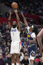 Los Angeles Clippers guard James Harden, left, shoots as Denver Nuggets guard Kentavious Caldwell-Pope defends during the second half of an NBA basketball game Thursday, April 4, 2024, in Los Angeles. (AP Photo/Mark J. Terrill)