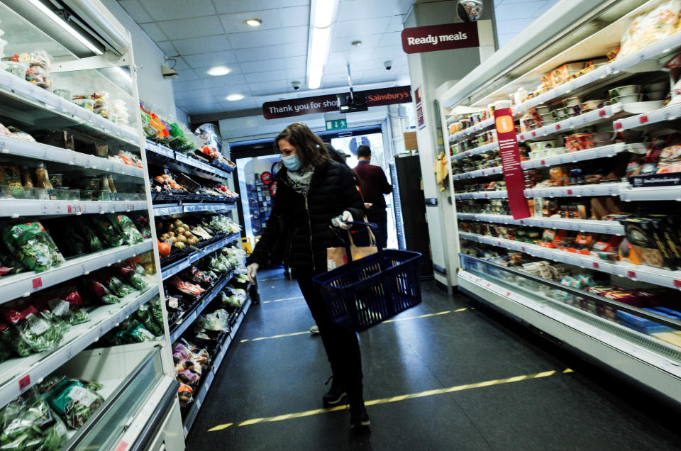 A woman wearing a mask and latex gloves shops in a branch of Sainsbury's in Bayswater, London, England. Photo: David Cliff/NurPhoto via Getty Images