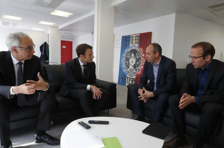 Emmanuel Macron (2ndL), head of the political movement En Marche!, or Onwards!, and candidate for the 2017 presidential election, attends a meeting with French CFDT labour union leader Laurent Berger (2ndR) as French economist and public policy expert Jean Pisani-Ferry (L) and Frederic Seve (R), general secretary of Sgen- CFDT, listen at his campaign headquarters in Paris, France, April 20, 2017. REUTERS/Philippe Wojazer