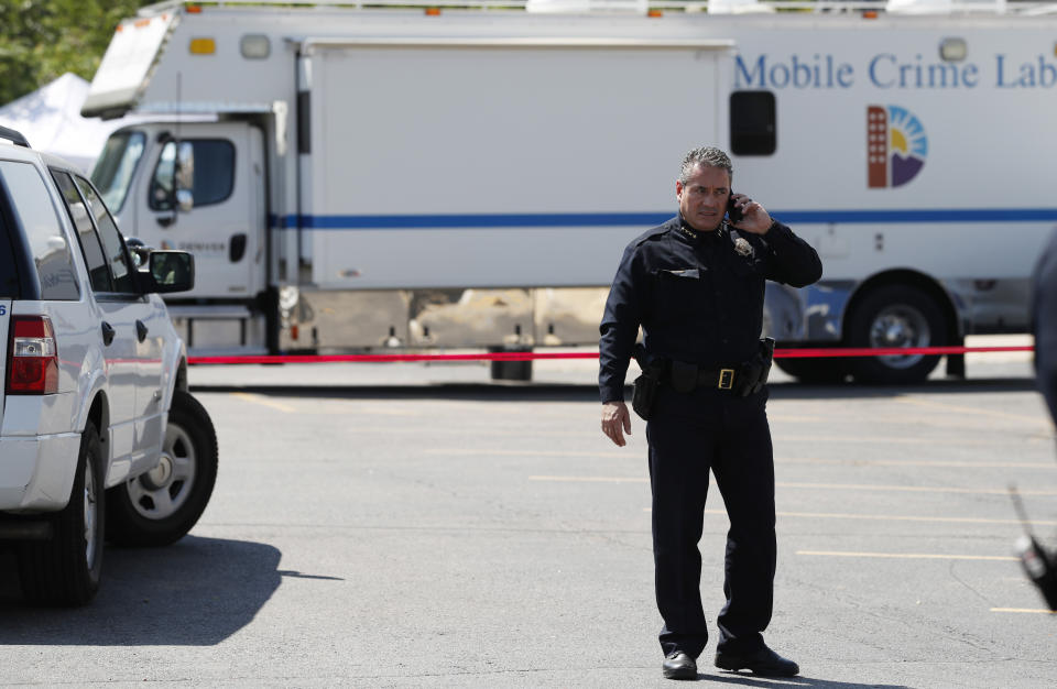 Denver Police Chef Paul Pazen talks on a mobile telephone near the scene of a triple homicide south of downtown Denver, Thursday, Aug. 9, 2018. Police are trying to determine if the deaths of three homeless people are related to an earlier stabbing in the area. (AP Photo/David Zalubowski)