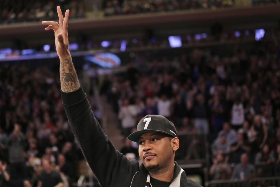 Former New York Knick Carmelo Anthony acknowledges the crowd during the first half of the NBA basketball game between the New York Knicks and the Miami Heat, Sunday, Jan. 27, 2019, in New York. (AP Photo/Seth Wenig)