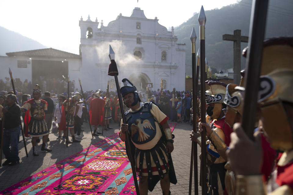 Faithful dressed as Roman soldiers take part in a Holy Thursday procession outside the San Cristobal el Bajo Catholic church, in Antigua, Guatemala, Thursday, April 6, 2023. (AP Photo/Moises Castillo)