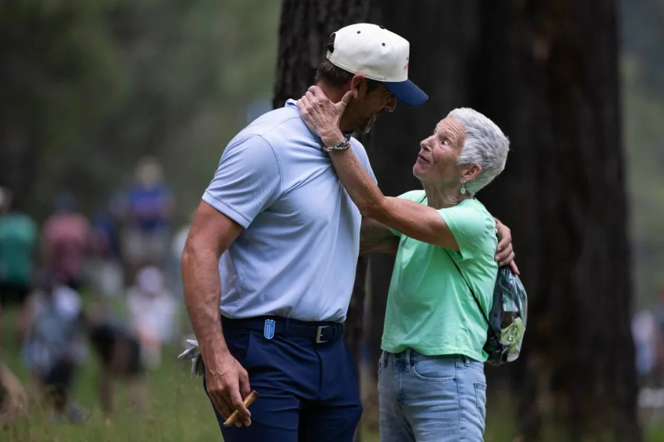 New York Jets quarterback Aaron Rodgers is embraced by longtime friend Carol Sargent during the first round of the American Century celebrity golf championship on Friday, July 12, 2024, in Stateline, Nev.