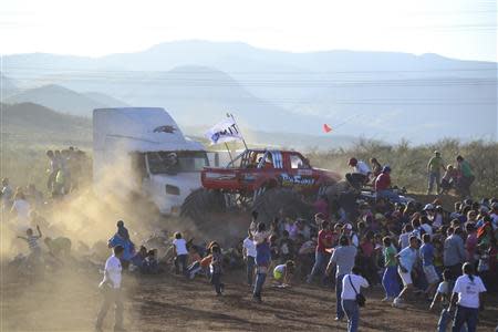 A monster truck rams into spectators during a monster truck rally show at El Rejon park, on the outskirts of Chihuahua October 5, 2013. REUTERS/Eduardo Alanis/El Diario de Chihuahua