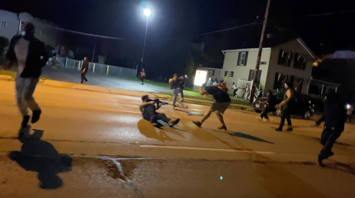 Men scuffle during a protest Tuesday following the police shooting of Jacob Blake, a Black man, in Kenosha, Wisconsin, in this still image obtained from a social media video. (Photo: Brendan Gutenschwager via REUTERS)