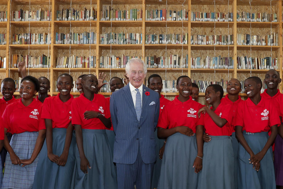 FILE - Britain's King Charles III, center, poses for a photograph with secondary school students during his visit to the Eastlands Library to learn about a project that restores old libraries and encourages reading amongst children in the community in Makadara district of Nairobi, Oct. 31, 2023. King Charles III is on the comeback trail. The 75-year-old British monarch will slowly ease back into public life after a three-month break to focus on his treatment and recuperation after he was diagnosed with an undisclosed type of cancer. (Thomas Mukoya/Pool Photo via AP, File)