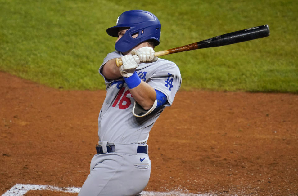 Los Angeles Dodgers' Will Smith follows through on a two-run double off Colorado Rockies relief pitcher Carlos Estevez during the seventh inning of a baseball game Thursday, Sept. 17, 2020, in Denver. (AP Photo/David Zalubowski)