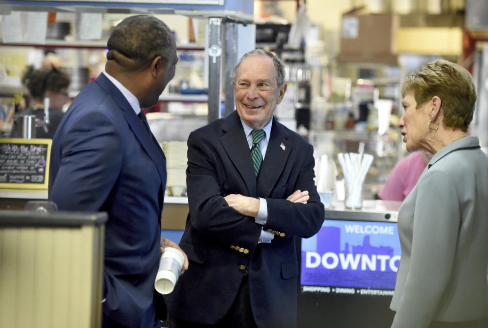 Democratic presidential candidate and former New York Mayor Michael Bloomberg, middle, and Augusta, Ga., Mayor Hardie Davis, left, chat with a woman at the New Moon Cafe in Augusta, Ga., Friday, Dec. 6, 2019. (Michael Holahan/The Augusta Chronicle via AP)