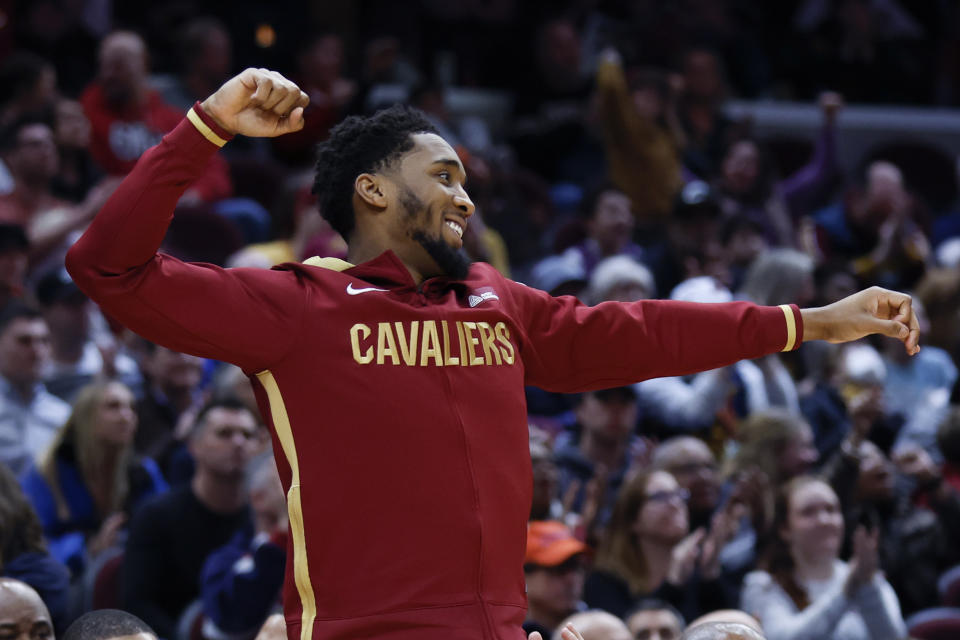 Cleveland Cavaliers guard Donovan Mitchell cheers from the bench during the second half of an NBA basketball game against the New Orleans Pelicans, Monday, Jan. 16, 2023, in Cleveland. (AP Photo/Ron Schwane)