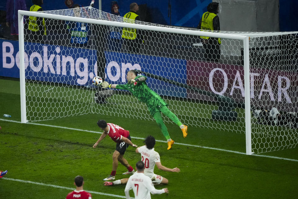 Turkey's goalkeeper Mert Gunok saves the ball during a round of sixteen match between Austria and Turkey at the Euro 2024 soccer tournament in Leipzig, Germany, Tuesday, July 2, 2024. (AP Photo/Ebrahim Noroozi)