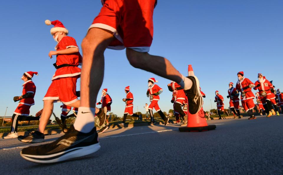 More than 800 runners dressed as Santa Claus braved near freezing temperatures to participate in the Run Run Santa 1 Mile Saturday Dec. 24, 2022 in Viera, Fla (AP)