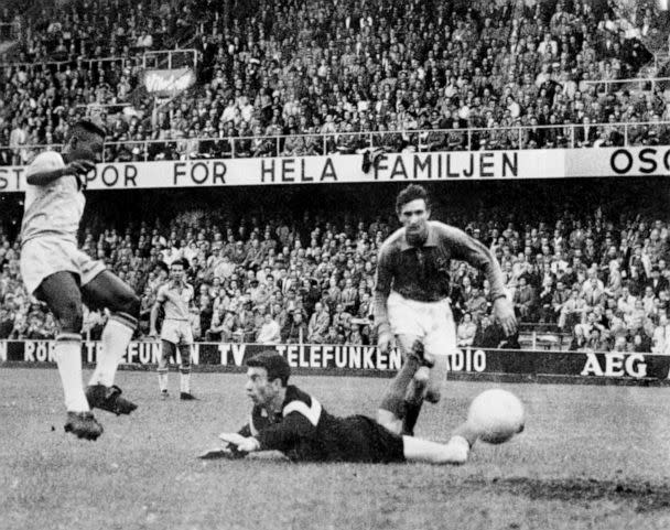 PHOTO: Brazil's Pele steers the ball past France goalkeeper Claude Abbes to score his team's third goal during the 1958 World Cup. Brazil won the final match 5-2. (PA Images via Getty Images, FILE)