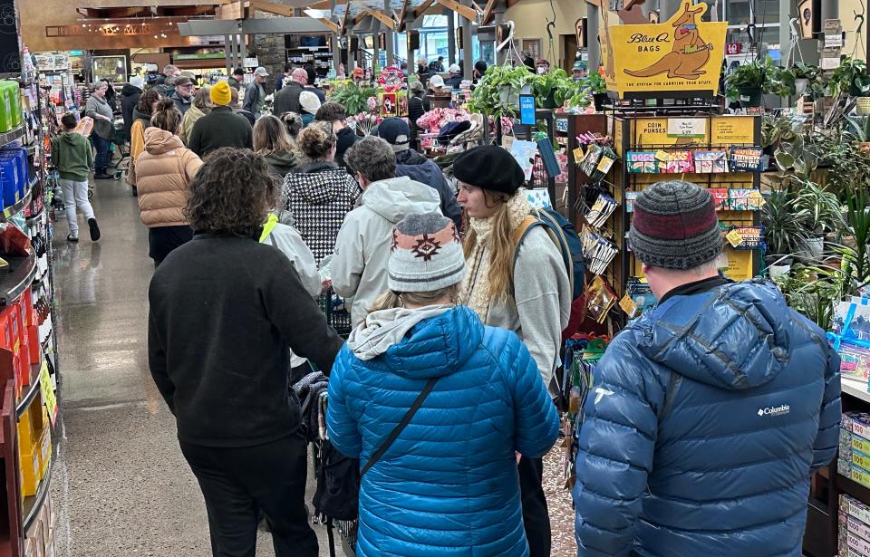 As the ice thaws, shoppers line up at Market of Choice in Eugene for supplies.