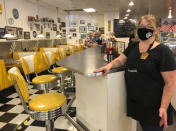 Restaurant manager Lori Pack stands at the counter of Linda's Soda Bar and Grill in Yuba City, Calif., Thursday, July 9, 2020. Sutter County was one of the first counties to reopen its economy when it defied Gov. Gavin Newsom's stay-at-home order in May to allow restaurants, hair salons, gyms and shopping malls to reopen. But Thursday, the county was added to a state watch list because of its rising number of coronavirus cases and hospitalizations. That will eventually trigger another round of restrictions, forcing bars to close and indoor operations to cease at restaurants and other public places for three weeks. Pack says the restaurant tried takeout-only service for three weeks earlier this year during the coronavirus pandemic. But she said it was "just not sustainable." (AP Photo/Adam Beam)