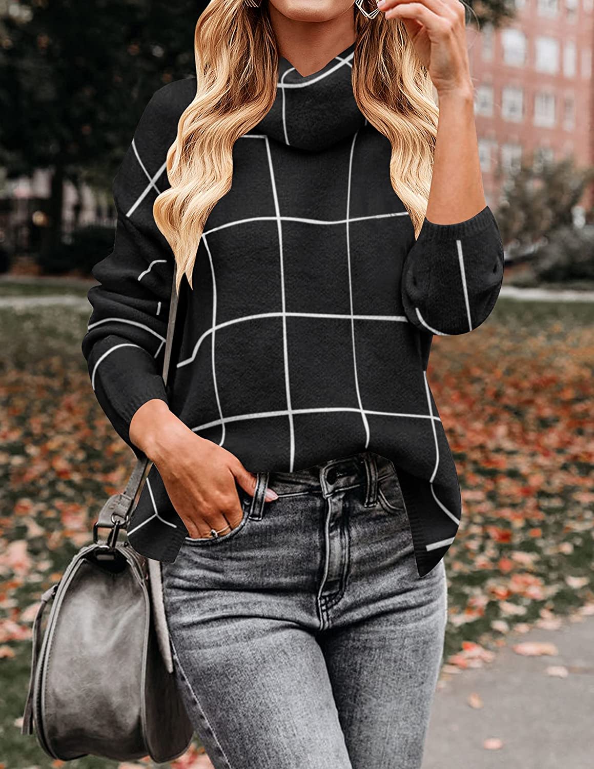 person wearing black sweater with white lines