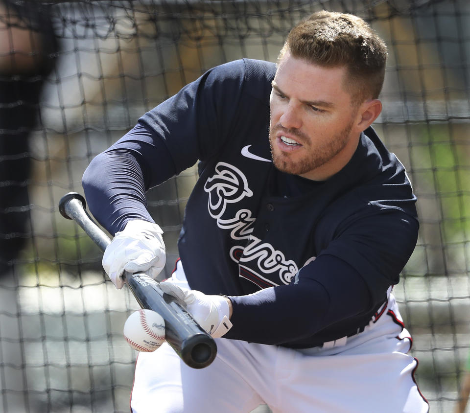 Atlanta Braves first baseman Freddie Freeman lays down a bunt during a spring training baseball practice in North Port, Fla., Tuesday, Feb. 18, 2020. (Curtis Compton/Atlanta Journal-Constitution via AP)