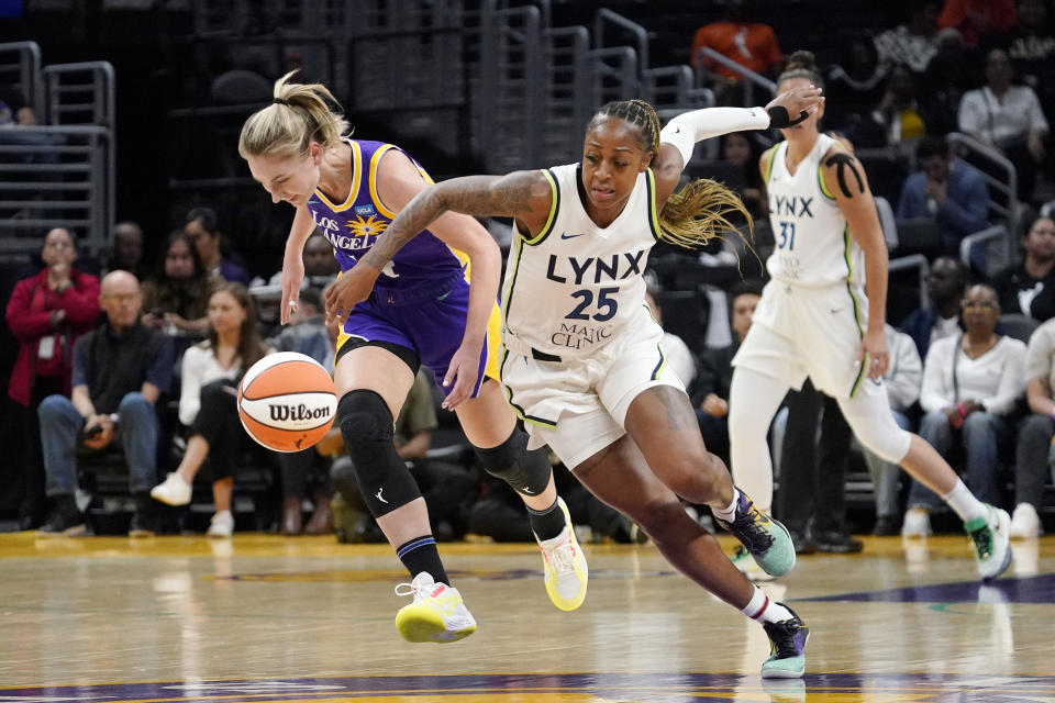 Minnesota Lynx guard Tiffany Mitchell, right, goes after a loose ball along with Los Angeles Sparks Karlie Samuelson during the first half of a WNBA basketball game Tuesday, June 20, 2023, in Los Angeles. (AP Photo/Mark J. Terrill)