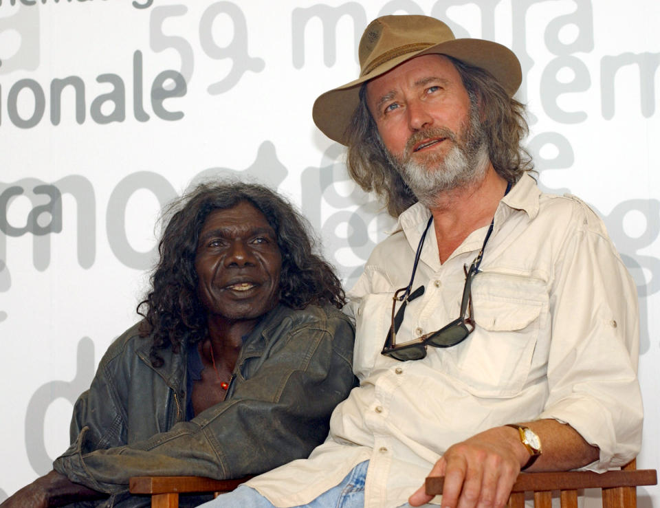 FILE - Australian Indigenous actor David Gulpilil, left, and Dutch-Australian movie director Rolf De Heer smile during a photocall in Venice, Italy, Friday, Sept. 6, 2002. Gulpilil has died of lung cancer, a government leader said on Monday, Nov. 29, 2021. He was 68 years old. (AP Photo/Francesco Proietti, File)