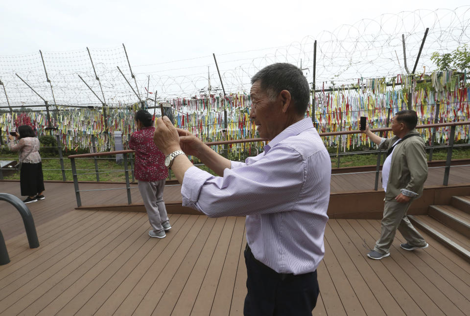 Visitors take photos toward the North's side at the Imjingak Pavilion, near the demilitarized zone of Panmunjom, in Paju, South Korea, Thursday, June 20, 2019. Chinese President Xi Jinping departed Thursday morning for a state visit to North Korea, where he's expected to talk with leader Kim Jong Un about his nuclear program while negotiations have stalled with Washington. (AP Photo/Ahn Young-joon)