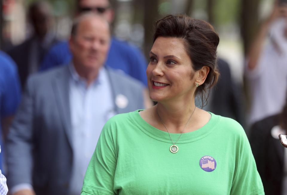 Michigan Democratic gubernatorial candidate Gretchen Whitmer walks on Livernois Ave. as she tours the area with Mayor Mike Duggan, Tuesday, Aug. 7, 2018, in Detroit. (AP Photo/Carlos Osorio)